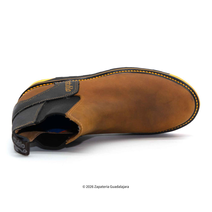 Brown leather shoe with yellow stitching on a white background