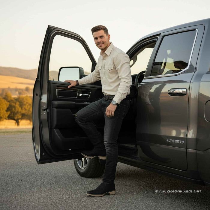 Man getting out of a black SUV with a scenic background