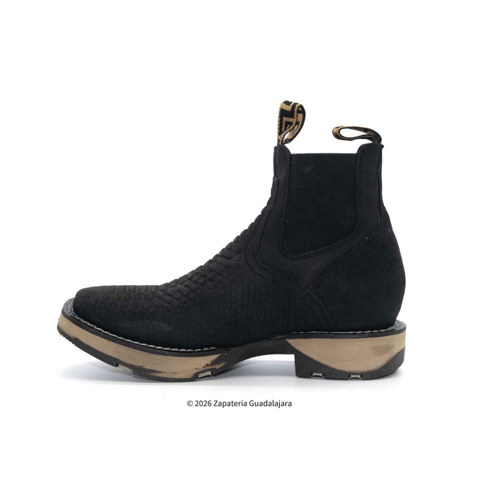 Black Chelsea boot on a white background