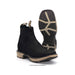 Black cowboy boots with tan soles on a white background