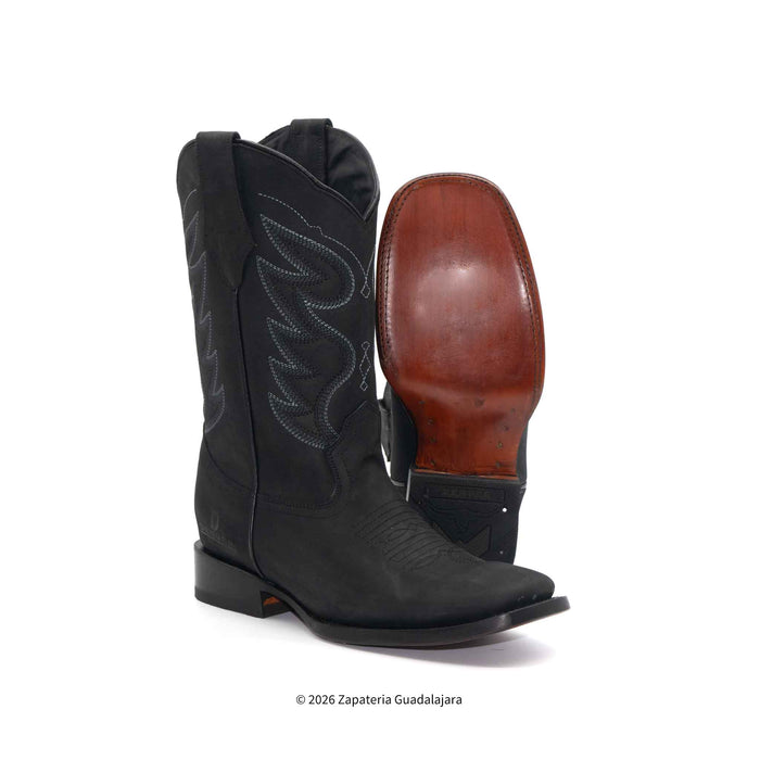 Black cowboy boot with brown sole on a white background