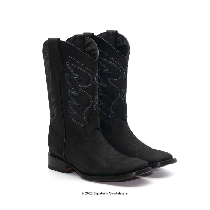 Pair of black cowboy boots with intricate designs on a white background