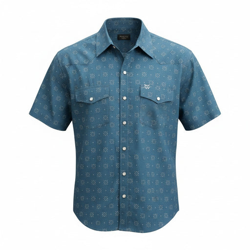 A short-sleeve western-style button-up shirt in slate blue with a repeating white geometric pattern, featuring two buttoned chest pockets and a white embroidered logo on the left chest, shown against a plain white background.