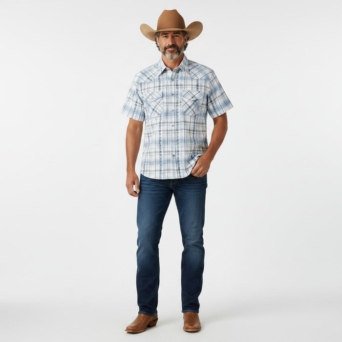 A man modeling a short-sleeve western plaid button-down shirt, dark blue jeans, a brown cowboy hat, and brown boots against a plain white studio background.