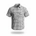 A short-sleeve button-up shirt with a light gray and white base featuring a black tropical beach print of palm trees, umbrellas, and waves, shown on a clean white background with a soft drop shadow.