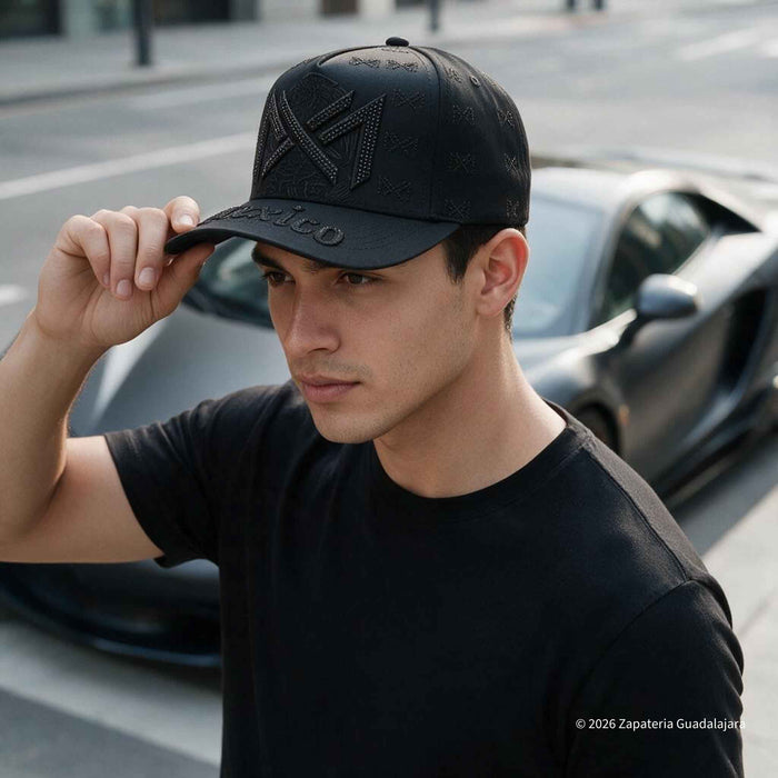 a young guy wearing a black cap wiith mexico emroidered with rhinestones
