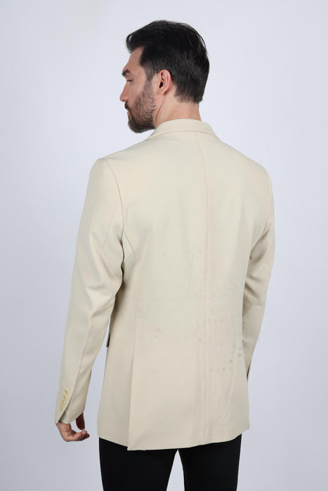 Man wearing a beige blazer on a white background