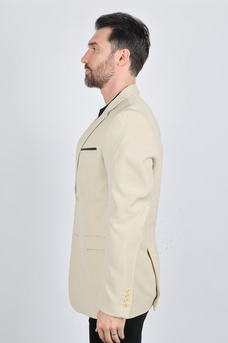 Man wearing a beige blazer on a white background