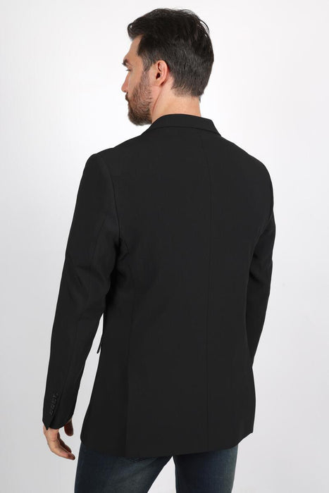 Man wearing a black coat on a white background