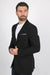 Man wearing a black blazer over a white shirt on a white background