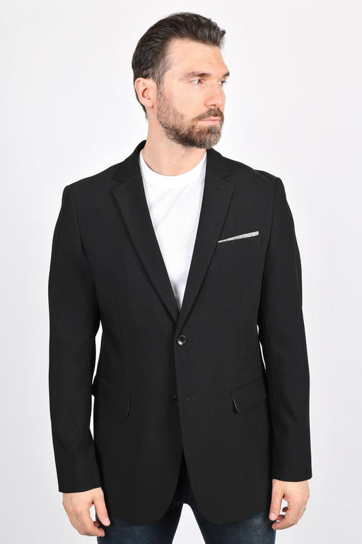 Man wearing a black blazer over a white shirt on a white background