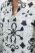 Close-up of a white shirt with black floral patterns