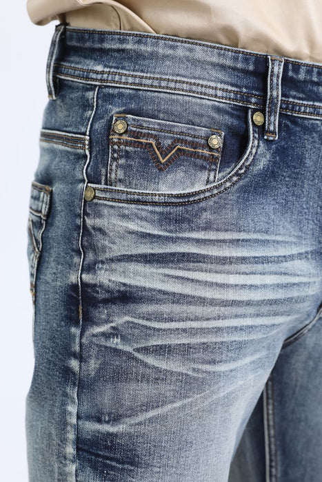 Close-up of blue jeans with a brand logo on the pocket against a white background