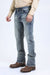 Person wearing light blue jeans and brown shoes on a white background