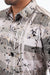 Close-up of a patterned shirt with abstract design and geometric elements.