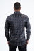 Man wearing a patterned shirt from behind on a white background