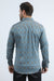 Man wearing a blue patterned shirt on a white background