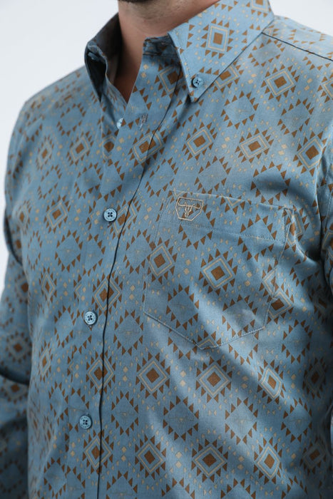 Close-up of a patterned shirt with a visible brand logo on a light background