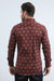 Man wearing a patterned red shirt on a white background