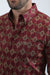 Maroon patterned shirt worn by a person on a white background
