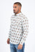 Man wearing a patterned shirt and jeans on a white background