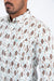 Man wearing a patterned shirt with a neutral background