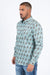 Man wearing a patterned shirt and jeans on a white background