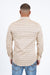 Man wearing a patterned shirt and jeans on a white background