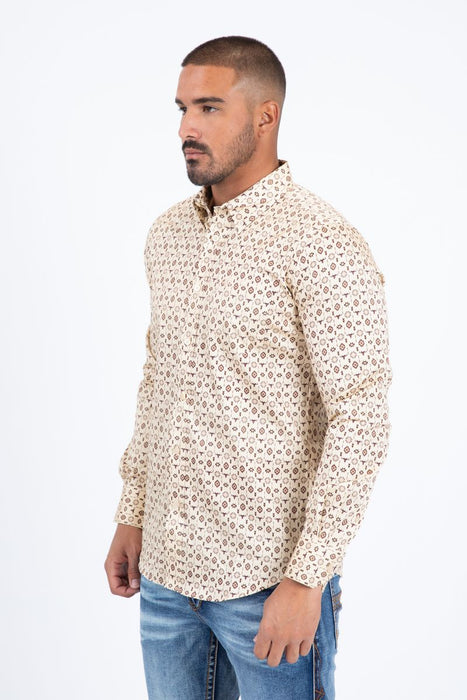 Man wearing a patterned shirt and jeans on a white background