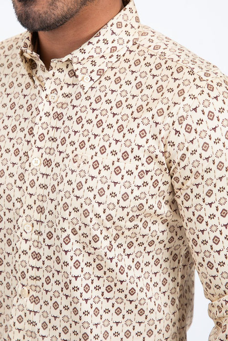 Beige shirt with a subtle pattern worn by a person on a white background