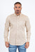 Man wearing a patterned shirt and jeans on a white background