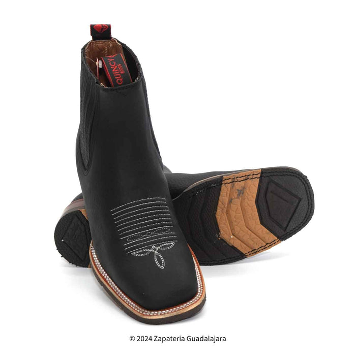 Black leather boots with brown accents on a white background