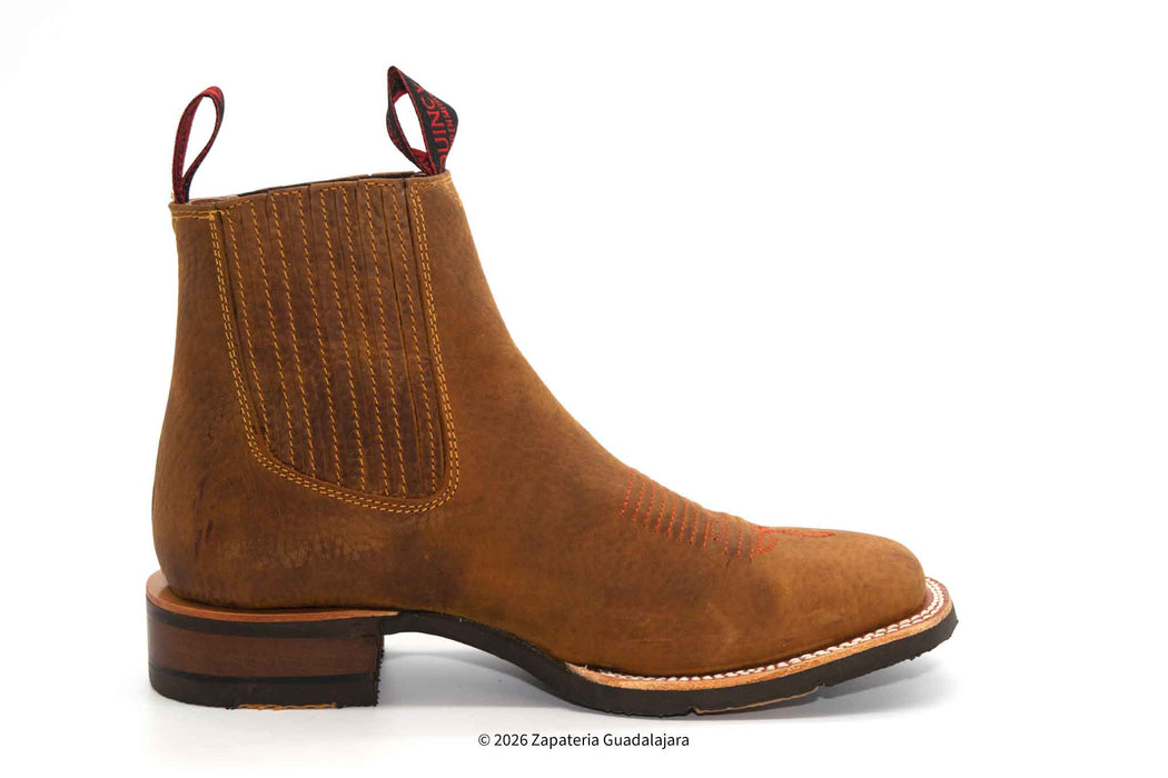 a pair of tan brown leather boots with rubber sole and white background