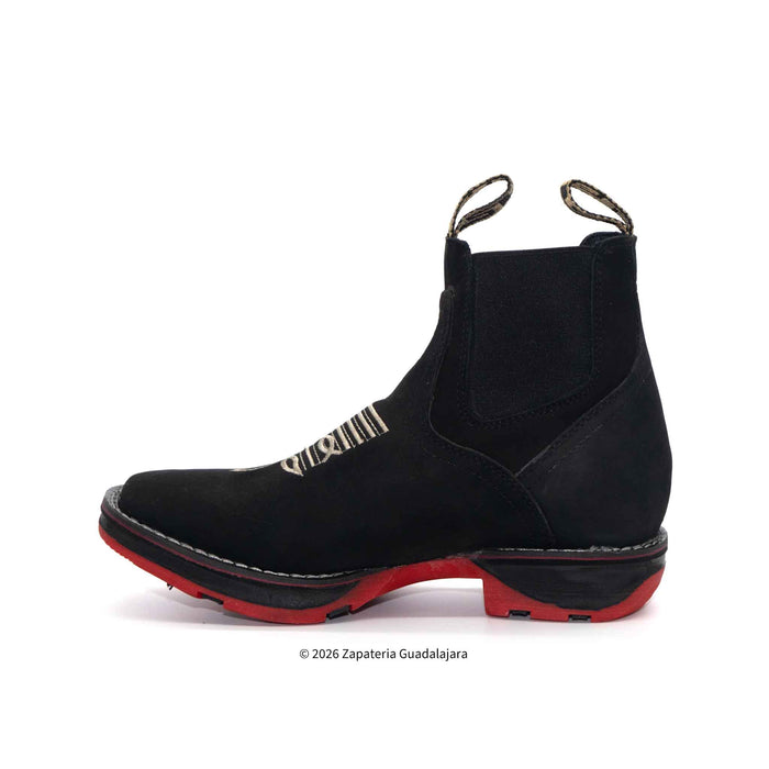 Black boot with red sole on a white background