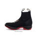 Black boot with red sole on a white background