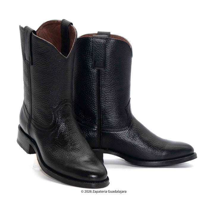 Pair of black leather boots on a white background
