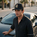 YOUN GUY WEARING A CAP WITH SANT JUDES EMBROIDERED BLACK CAP