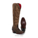 Brown cowboy boot with intricate design on a white background