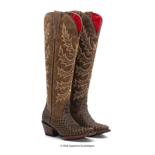 Brown cowboy boots with intricate patterns on a white background