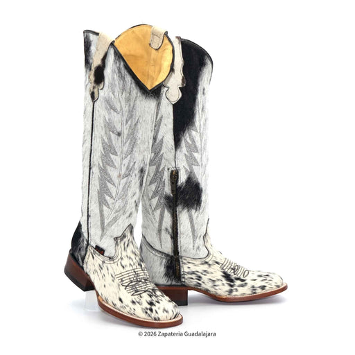 Pair of cowhide leather cowboy boots with a black and white pattern on a white background.