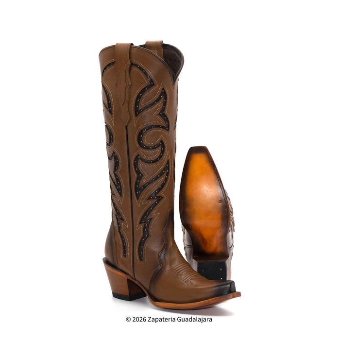 Brown cowboy boot with intricate black leatherwork on a white background