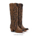 Brown cowboy boots with intricate black designs on a white background