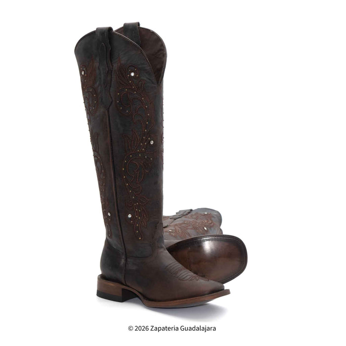 Pair of brown cowboy boots on a white background