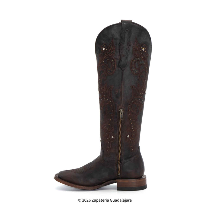Brown leather boot with intricate designs on a white background