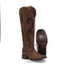 Brown cowboy boot with intricate designs on a white background