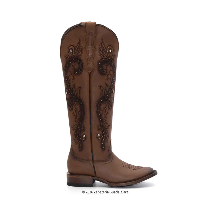 Brown cowboy boot with intricate designs on a white background