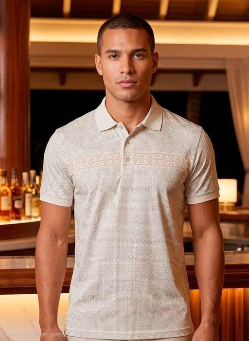 Man wearing a light-colored polo shirt in an indoor setting with warm lighting