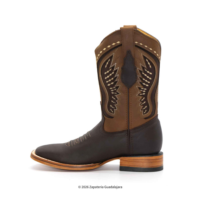 A single brown leather cowboy boot with a dark brown foot, embroidered wing-like shaft detailing, and a stacked wood-look heel, shown on a white background.
