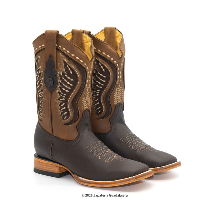 A pair of western cowboy boots in brown and black leather with tan embroidery, shown on a white background. A copyright watermark for 'Zapateria Guadalajara' is visible at the bottom.