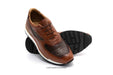 Brown leather shoe with a white sole on a white background